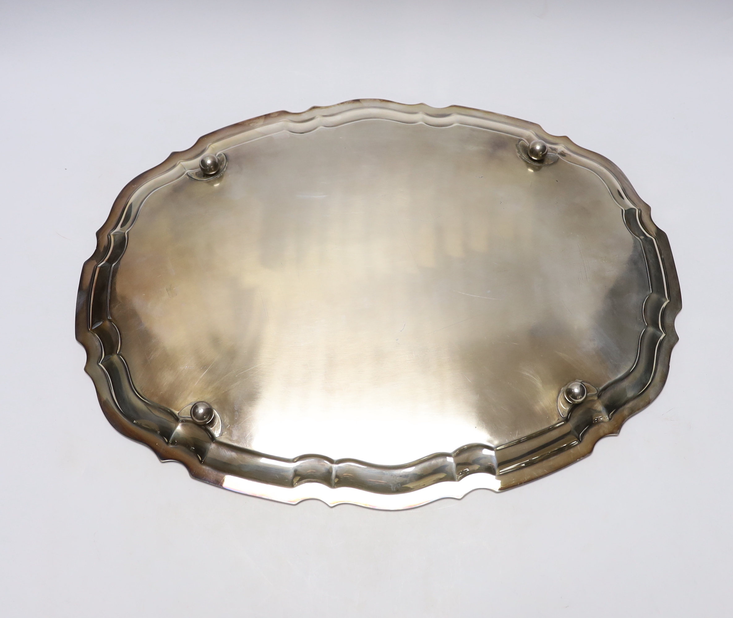 A George V silver shaped oval tray, by Viners Ltd, Sheffield, 1938?, on four ball feet, 46.5cm, 52.2oz.